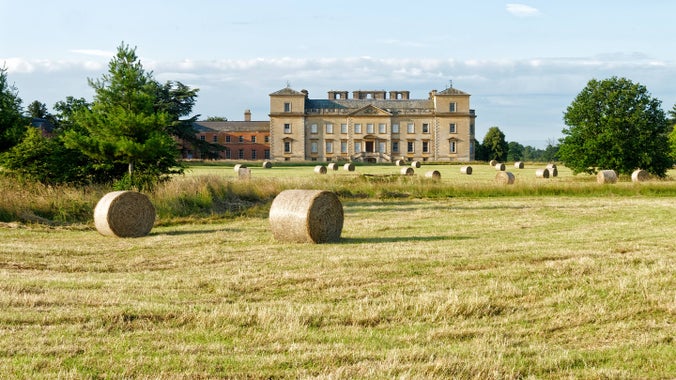 View of the house and hay bales in the parkland at Croome, Worcestershire